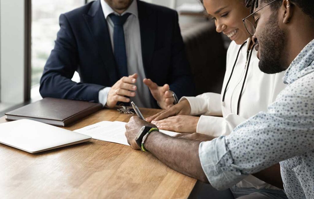 Person examining a home interior with a flashlight while checking walls, flooring, and under-sink plumbing.